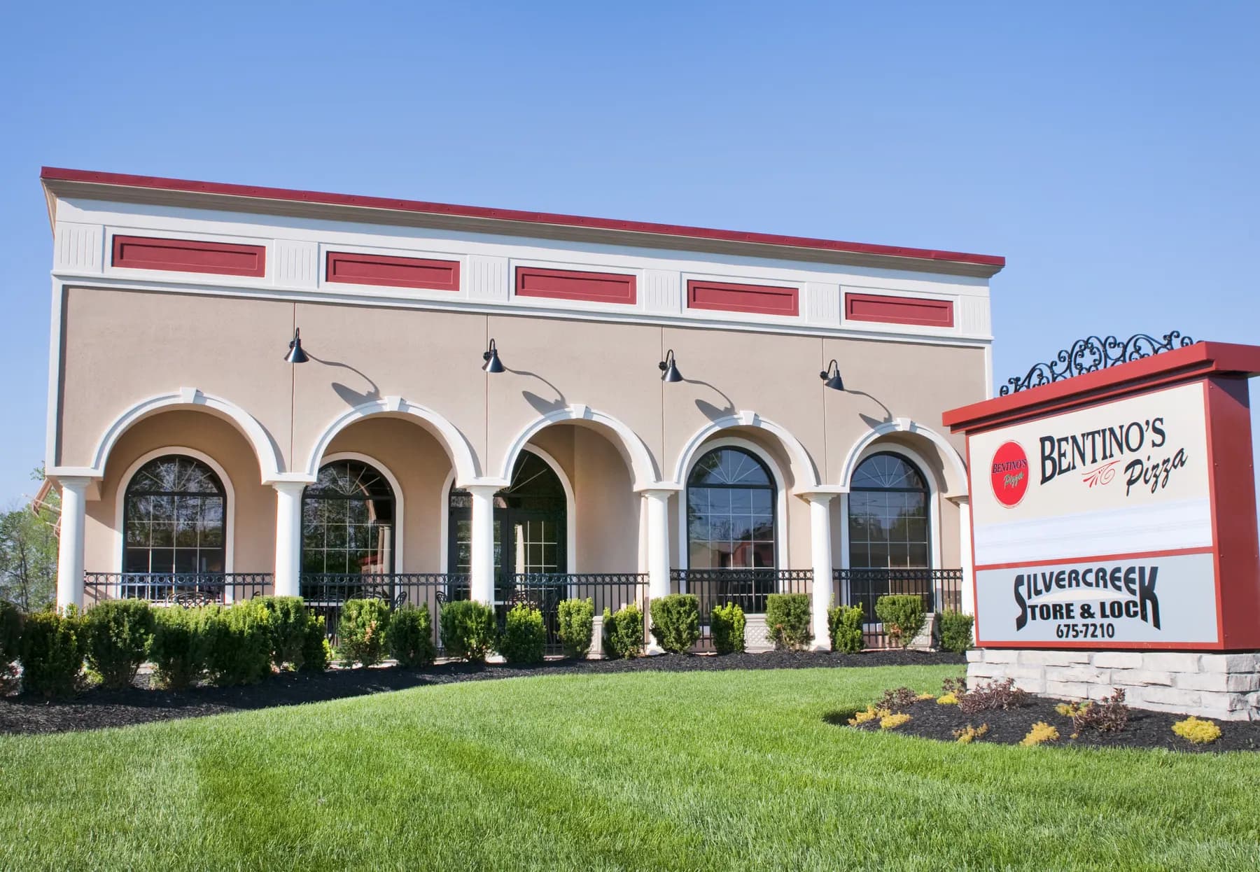 Bentino's storefront on West Washington with cream stucco, arches, and red trim